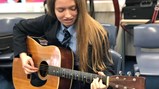 Esme rehearsing for Solo guitar performing