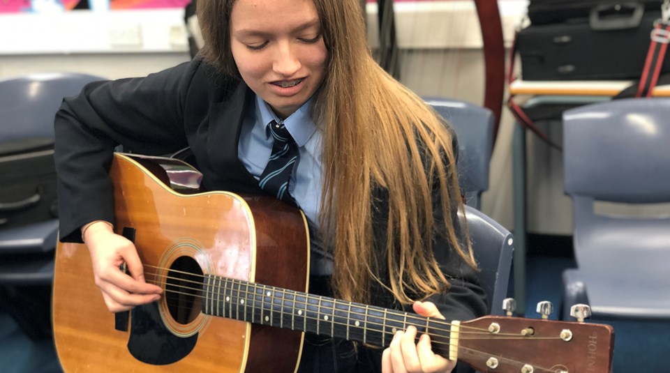 Esme rehearsing for Solo guitar performing